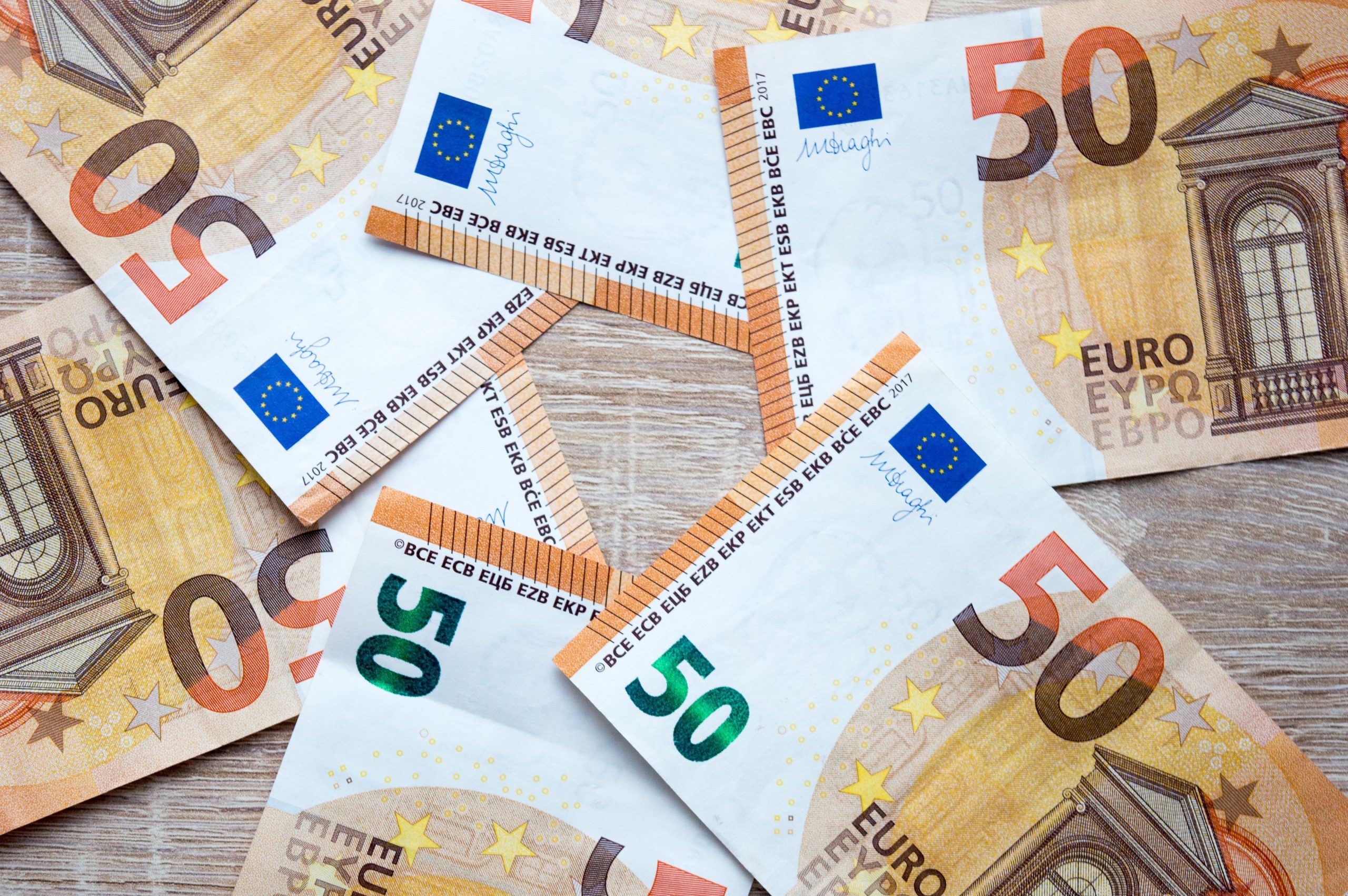 Billets de 50 euros éparpillés sur bois